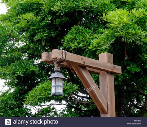 Rustic wooden lamp post tied together with rope. Foliage in Stock Photo: 174278581 - Alamy ...