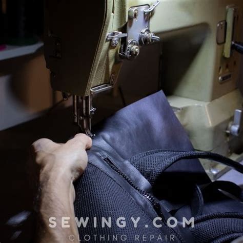 a person is sewing on a machine