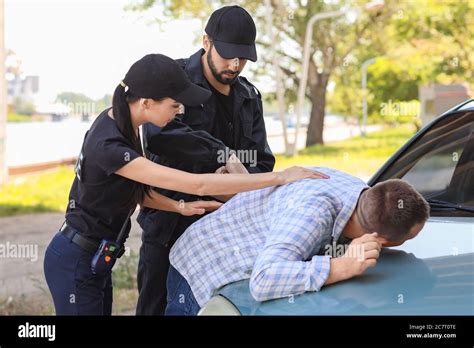 Female police officer arresting woman hi-res stock photography and ...