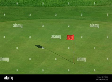 Golf field with red flag Stock Photo - Alamy