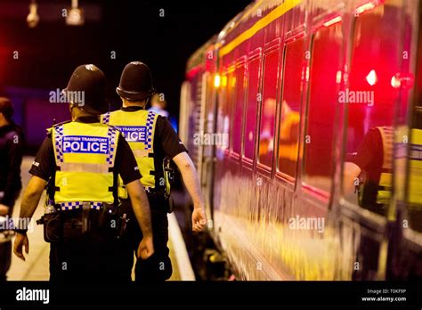 British transport Police in uniform walk along side a train Stock Photo ...