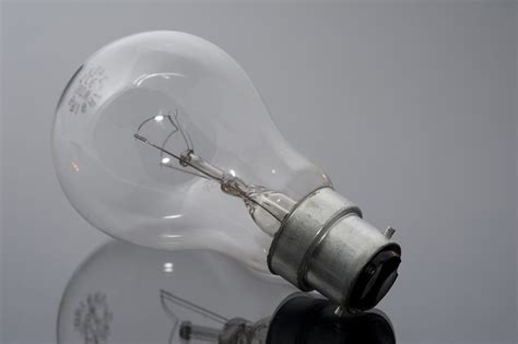 Free Image of Close up Unlit Bulb on Glossy Table | Freebie.Photography