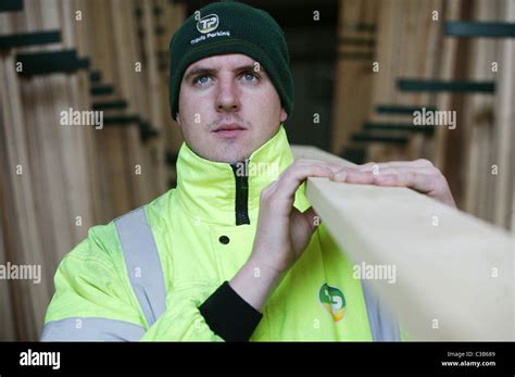 A worker at Travis Perkins loading timber Stock Photo - Alamy