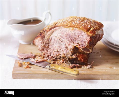 Slow-cooked pork shoulder and gravy Stock Photo - Alamy