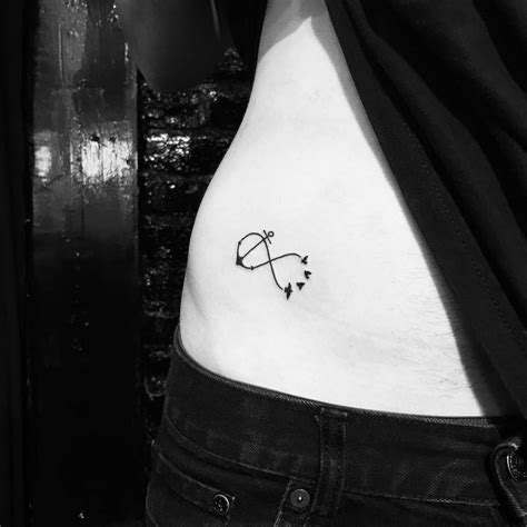 Minimalistic infinity symbol tattoo located on the hip.