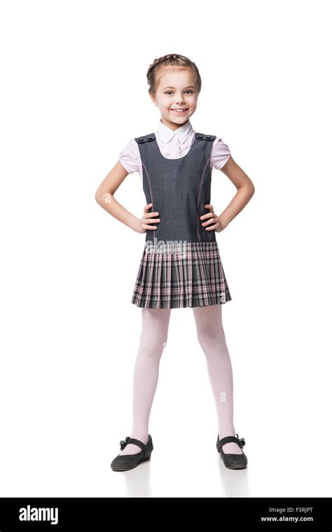 Beautiful little girl in school uniform isolated on white Stock Photo ...