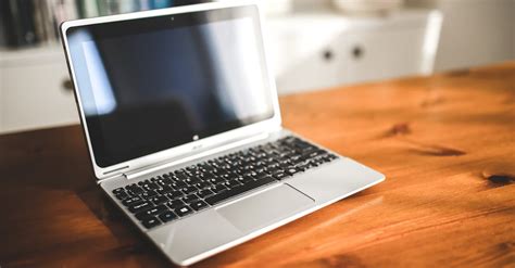 Opened laptop computer on a wooden desk · Free Stock Photo