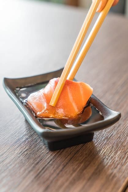 Premium Photo | Salmon sashimi with soy sauce