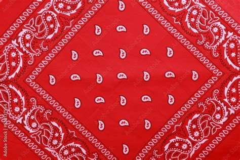 Top view of red bandana with paisley pattern as background Stock Photo | Adobe Stock