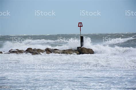 Waves Splash Into Groyne At A Beach In The Uk Stock Photo - Download ...