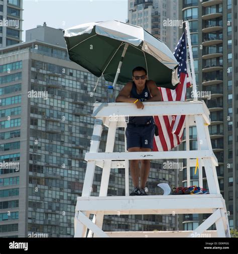 Lifeguard standing on a lifeguard's tower, Chicago, Cook County ...