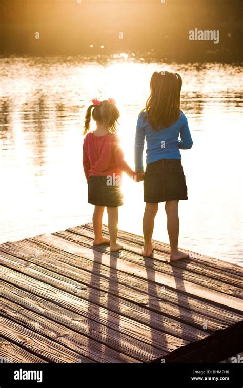 sisters holding hands Stock Photo - Alamy