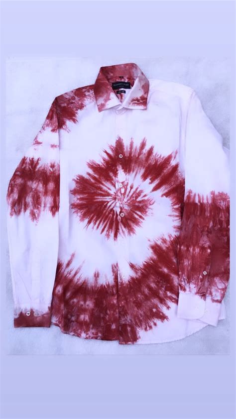 a red and white tie - dyed shirt on a light blue background