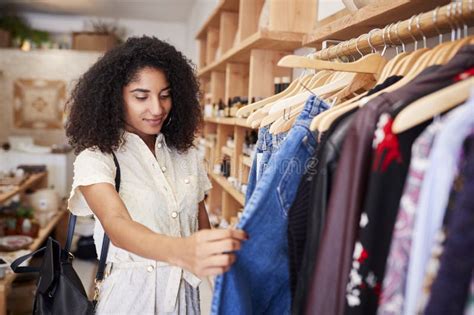 Female Customer Shopping in Independent Clothing Store Looking at Racks Stock Photo - Image of ...