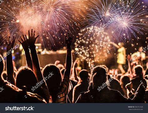 New Year Concept - Cheering Crowd And Fireworks Stock Photo 506751328 : Shutterstock