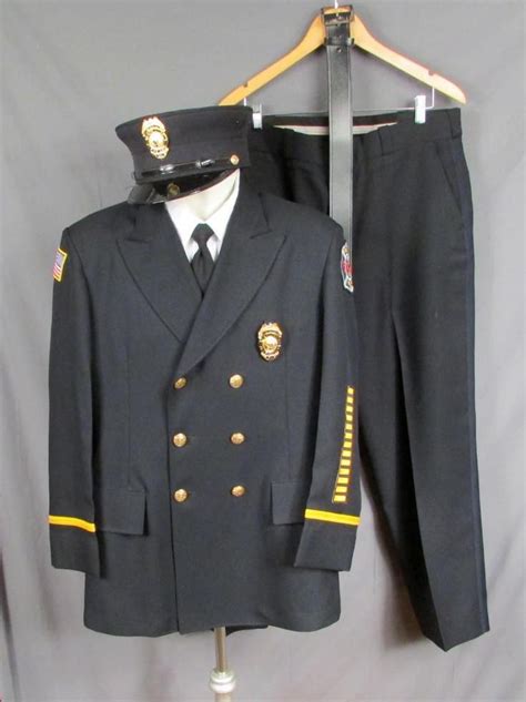 Firefighters Full Dress Uniform w/Cap & 2 Badges. All are in very nice Condition. Jacket Has ...