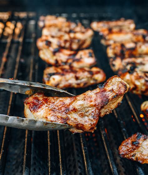 grilling individual ribs with metal tongs