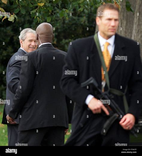 President George W Bush is guarded by Secret Service Agents during his ...