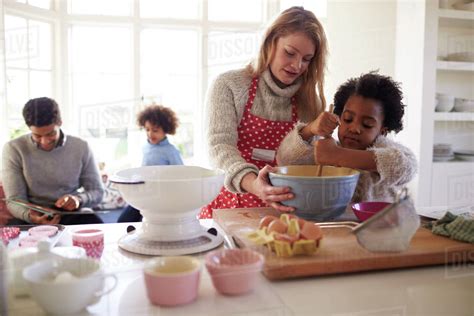 Family baking cake in kitchen at home together - Stock Photo - Dissolve