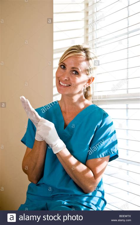 Female nurse in scrubs and protective gloves Stock Photo - Alamy