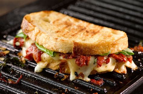 Grilled Cheese Sandwich oozing with melted cheese, roasted tomato and ...