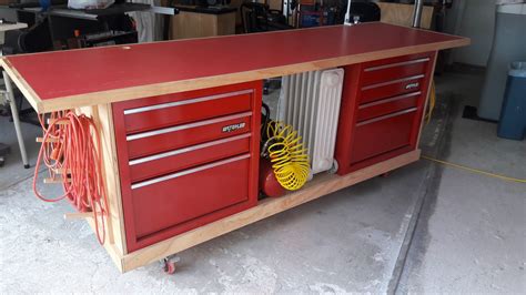 a red workbench with tools on it in a garage