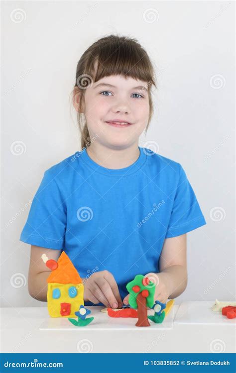 Smiling Girl Molds Toys from Plasticine on White Table Stock Photo - Image of clay, making ...