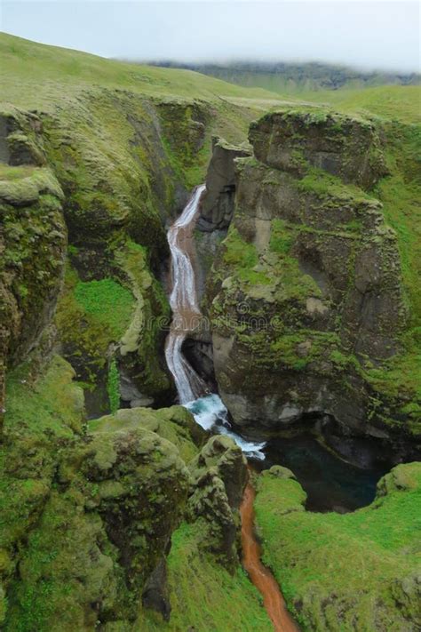 Waterfall at Fjadrargljufur Canyon, River Cutting through Green Rocks ...