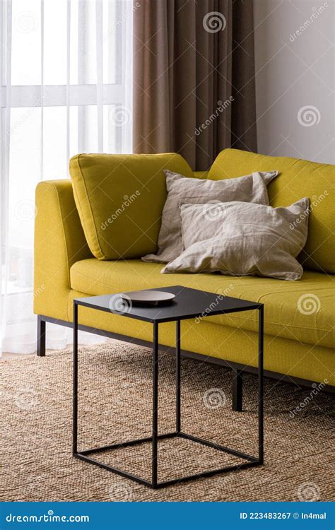Stylish Black Coffee Table and Modern Yellow Couch Stock Image - Image ...