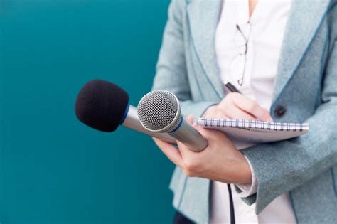 News reporter or TV journalist at press conference, holding microphone ...