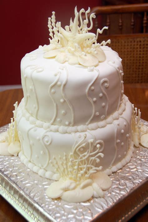 Seaside wedding cake. White chocolate shells and seaweed...fondant over butter cream icing ...