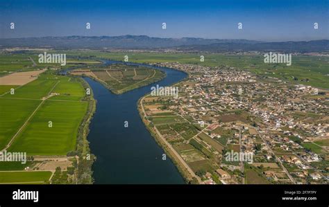 Aerial view of the town of Deltebre and the Ebro river in the Ebro Delta (Tarragona province ...