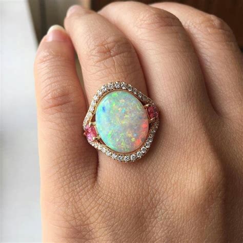 Falling for these amazing opals from @omiprive. This Australian is a modest 4.41ct and set in ...