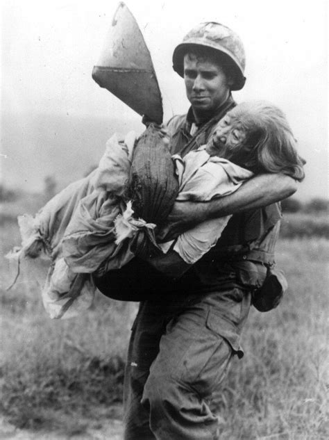 Us soldier from Portsmouth carrying an elderly Vietnamese woman,Vietnam ...