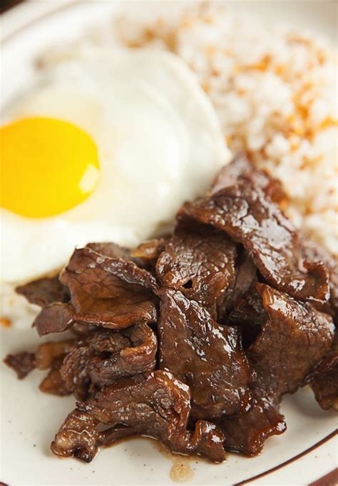 The Filipino breakfast Tapsilog combines marinated beef tapa with fried rice and a sunny side up ...