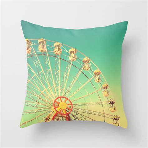 a green and yellow pillow with a ferris wheel