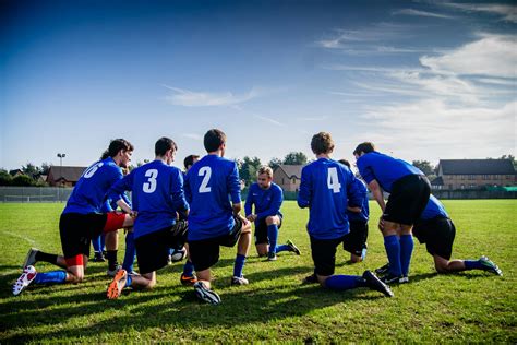 Group of Sports Player Kneeling on Field · Free Stock Photo
