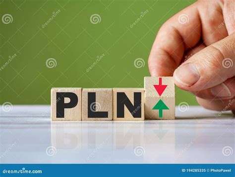 Word PLN Currency Symbol Concept and Hand Turn Wooden Block and Change Red Arrow To Green or ...