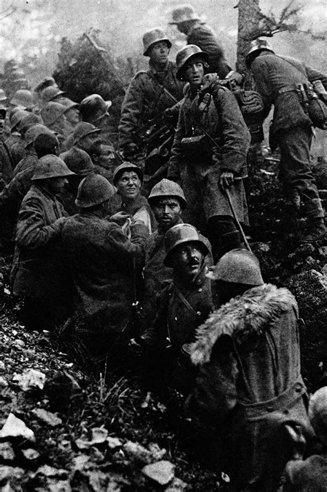 Captured Italian soldiers are escorted to the rear by German soldiers during the Battle of ...