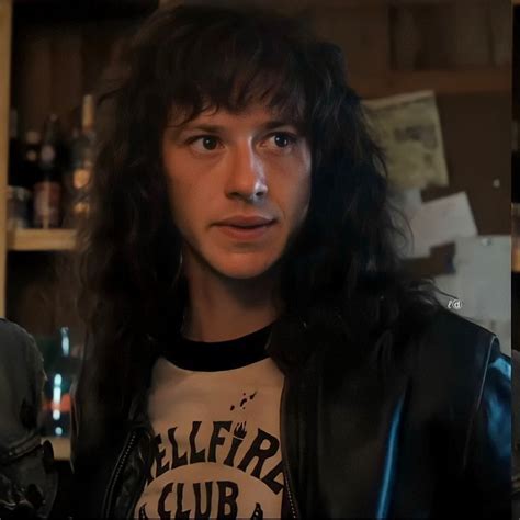 a man with long hair wearing a black leather jacket