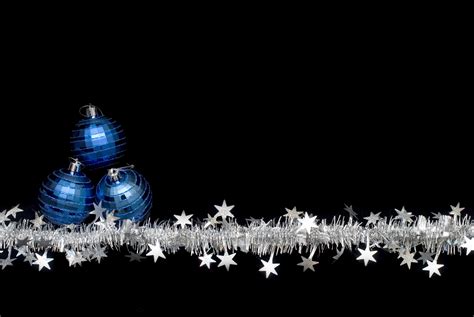 Photo of tinsel and three blue baubles | Free christmas images