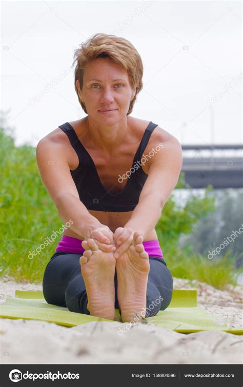 Hatha yoga. Paschimottanasan. Yoga poses, asan. Titl to feet. Concept of healthy life ...