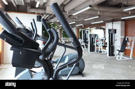 Empty gym with many gym equipment during day time Stock Photo - Alamy