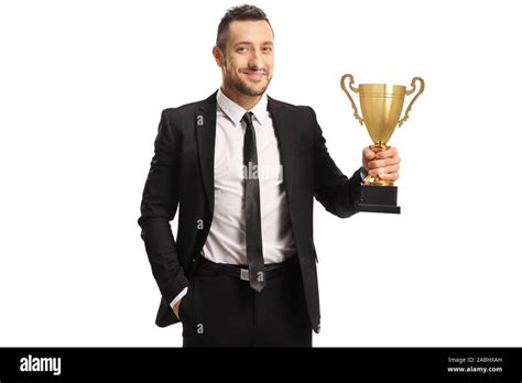 Young man in a suit and tie holding a trophy isolated on white ...