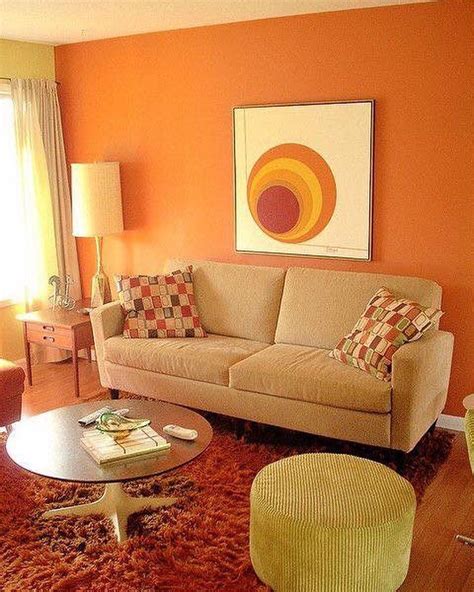 a living room with orange walls and furniture