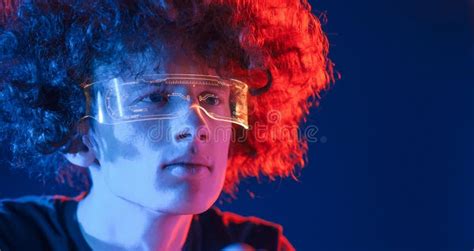 Futuristic Eyewear. Young Man with Curly Hair is Indoors Illuminated by ...