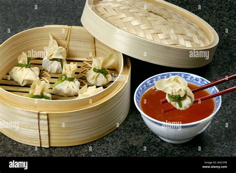 DIM SUM prepared in bamboo steamer with red hot sauce steam eat food asian Stock Photo - Alamy