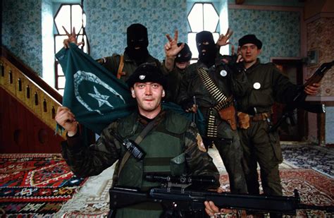 Soldiers from the Serb Paramilitary unit known as 'Arkans Tigers' pose with a muslim flag in a ...