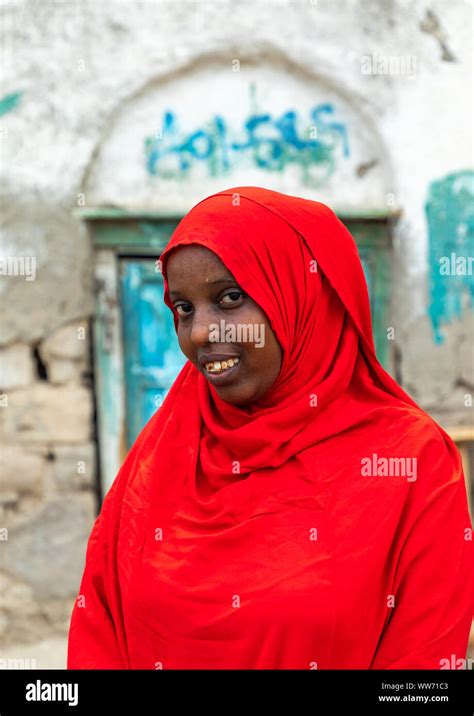 Portrait of a somali woman in red hijab in the streets of the old town, Sahil region, Berbera ...