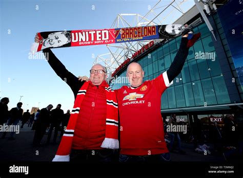 Manchester United fans holds up a commemorative match scarf outside the stadium ahead of the ...